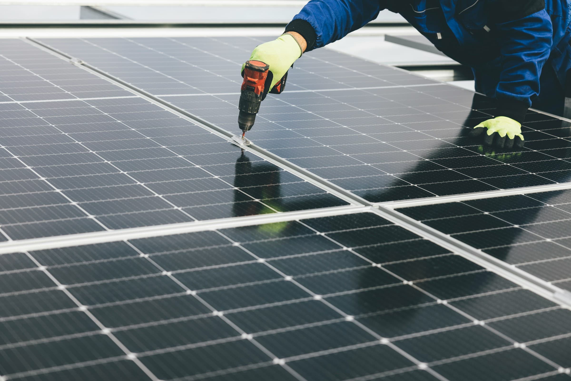 Installer securing solar panels